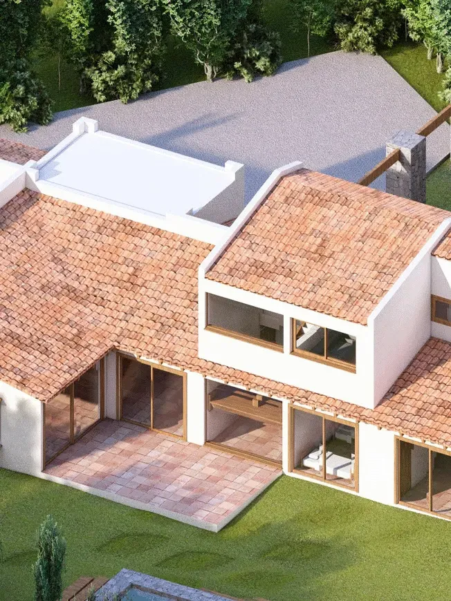 Vista aérea de casa en Marbella con techos de tejas, fachada blanca y grandes ventanales que abren a la terraza de pavimento cerámico