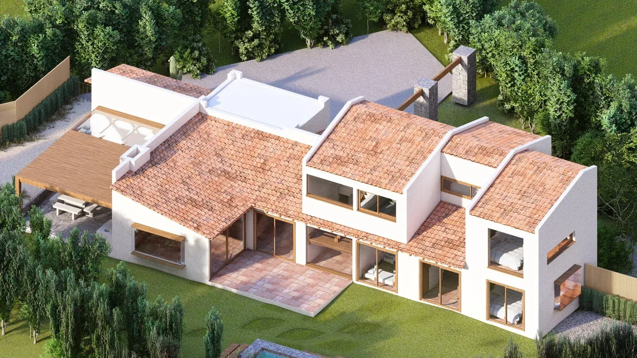 Vista aérea de casa en Marbella con techos de tejas, fachada blanca y grandes ventanales que abren a la terraza de pavimento cerámico